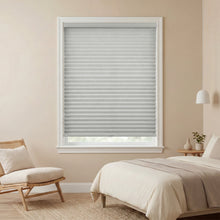 Load image into Gallery viewer, Slate gray pleated window shades in a bedroom with a bed and chair.