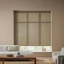 Load image into Gallery viewer, A stylish installation of Amelia Off White Millet Luxe natural light filtering roller shades, enhancing a modern interior space.