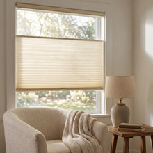 Load image into Gallery viewer, Simplistic Cordless Tdbu Pleated Shades effortlessly filter bright sunlight through beige treatments, complementing white walls and furniture in this serene room where versatility meets relaxation.