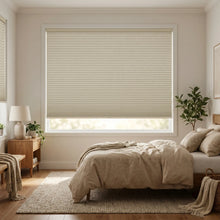 Load image into Gallery viewer, A look at Beige (Daylight) 1 2 Inch Budget Single Cell Blackout Cordless Shades inside a modern bedroom, shielding the interior from bright daylight and street lamps.