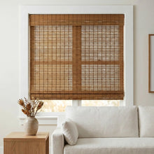 Load image into Gallery viewer, Cordless woven wood shades in beige perfectly complement the warm tones of this inviting living space, harmonizing with the white trim and matching walls
