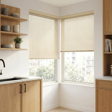 Load image into Gallery viewer, Natural sunlight hits the Beige (Vanilla Classic) Classic Cordless 6g Aluminum Mini Blinds in a cozy bathroom, perfect for high-traffic areas requiring durable light management.