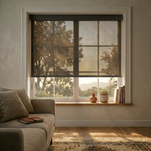 Load image into Gallery viewer, Modern Bronze Black Signature solar roller shades featuring 5% openness, highlighting the premium texture and clean fit within a white window frame above a wooden bench.