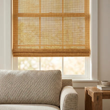 Load image into Gallery viewer, Introducing Cordless Woven Wood Shades in Brown, perfectly balancing warmth and natural light in this inviting living room with plush sectional sofa
