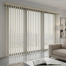 Load image into Gallery viewer, A warm living room featuring Creamy (Compose Ice Crystal) Signature Pvc Vertical Blinds, delivering sleek functionality and room-darkening capabilities.