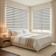 Load image into Gallery viewer, Modern bedroom serenity achieved with Zebra Light Filtering Roller Shades in creamy white, filtering natural light and maintaining privacy