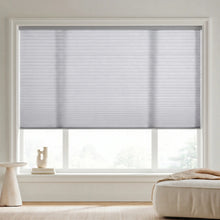 Load image into Gallery viewer, Custom window treatments: Creamy White (Grey Sheen) 7 16 Inch Double Cell Light Filtering Shades shown in a cozy living room, reducing screen glare while welcoming natural sunshine.