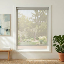 Load image into Gallery viewer, Premier 10% Solar Screen Roller Shade in Creamy White blocks UV rays while maintaining natural light, perfect for a serene reading nook.