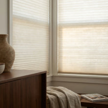 Load image into Gallery viewer, Showcasing Creamy White (Snow White) 7 16 Inch Double Cell Light Filtering Shades in a modern living space, softening harsh rays while keeping the space bright.