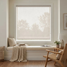 Load image into Gallery viewer, Classic Fabric Light Filtering Roller Shades in Creamy White filter natural light, creating a warm and inviting atmosphere in this cozy living room.
