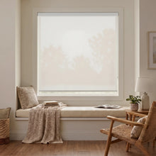 Load image into Gallery viewer, Classic Fabric Light Filtering Roller Shades in Creamy White filter natural light, creating a warm and inviting atmosphere in this cozy living room.