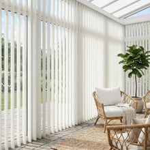 Load image into Gallery viewer, This serene living space is equipped with Crisp White (Wanderlust Vertical Snowdrift) Signature Pvc Vertical Blinds, ideal for expansive windows requiring versatile light management.