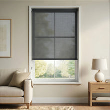 Load image into Gallery viewer, Functional Grey Black Signature solar roller shades in a living room setting, designed with 3% openness to protect hardwood floors and furniture from sun damage without losing the view.