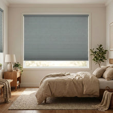 Load image into Gallery viewer, Styling a peaceful bedroom with Light Blue (Storm) 1 2 Inch Budget Single Cell Blackout Cordless Shades, offering maximum privacy and light control.