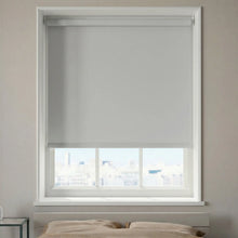 Load image into Gallery viewer, Main view of Matte Vinyl Grey ProGrade blackout roller shades providing total light blockage in a bright modern bedroom.
