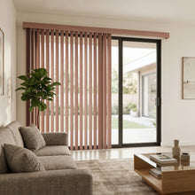 Load image into Gallery viewer, Woodtone Faux Wood PVC Vertical Blinds in Rosy add a touch of whimsy to this neutral-toned living room, where a gray couch and books on a coffee table create a inviting atmosphere.