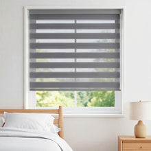 Load image into Gallery viewer, Add warmth and style to your bedroom with Zebra Solar Roller Shades, featuring soft gray shades that complement white decor.
