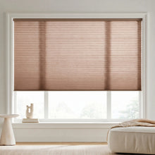 Load image into Gallery viewer, Sunlight hits the Warm Brown (Cocoa) 7 16 Inch Double Cell Light Filtering Shades in this cozy living space, delivering elegant light diffusion and daytime privacy.