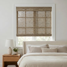 Load image into Gallery viewer, Introduce Cordless Woven Wood Shades with a rich Warm Brown striped pattern, perfectly complementing minimalist white decor and adding depth to this serene bedroom oasis.