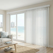 Load image into Gallery viewer, Natural sunlight hits the White (Ann Crystal) Signature Pvc Vertical Blinds in this modern living space, combining practical light filtering with a structured modern look.