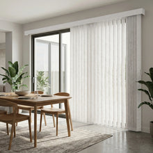 Load image into Gallery viewer, Interior view of a warm living space styled with White (Evelyn Bright White) Premier Pvc Vertical Blinds, allowing adjustable natural light through durable PVC vanes.