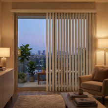Load image into Gallery viewer, White S Shaped Vertical Blinds in a cozy evening living room setting.