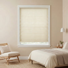 Load image into Gallery viewer, Beige pleated window shades in a bedroom with a bed and chair.
