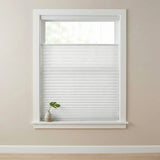 Close-up shot of white pleated shades with top-down-bottom-up functionality.