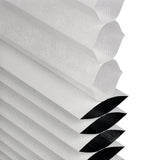 Close-up of a cellular blind honeycomb design internals showing blackout and light filtering functionality on a white background.