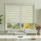Ivory window blinds in a kitchen with a view of trees outside.