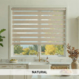 Kitchen window with zebra blinds in natural color, showing a view of trees outside.
