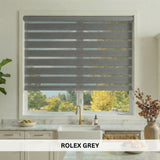Kitchen window with Rolex Grey blinds, showing a view of trees outside.