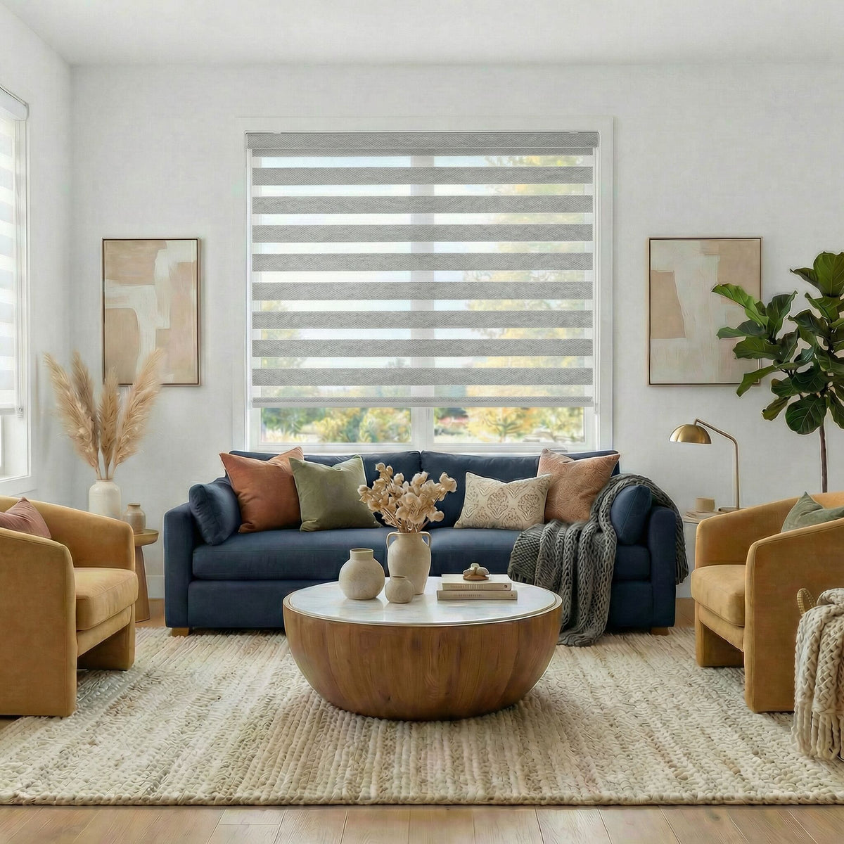 Light Grey "Shoreline" Zebra Solar Roller Shades in a cozy living room with a blue sofa, yellow armchairs, and a wooden coffee table.