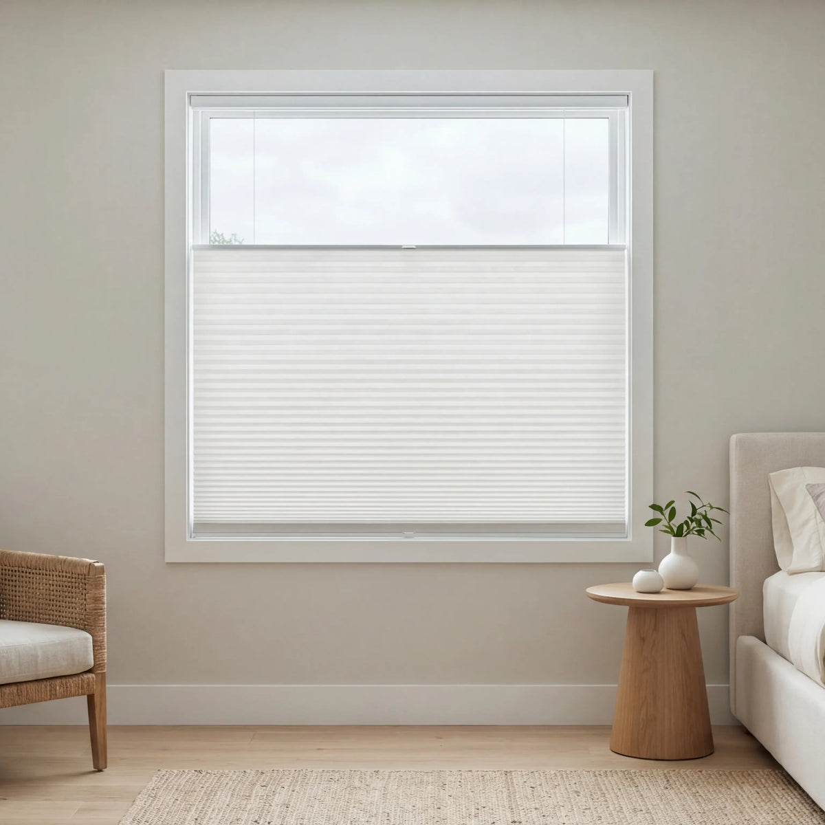 White pleated shades with top-down-bottom-up functionality in a bedroom providing privacy while giving maximum light.