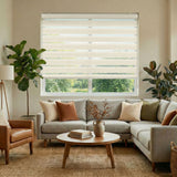 Living room with a sectional sofa, armchair, coffee table, and window with blinds.