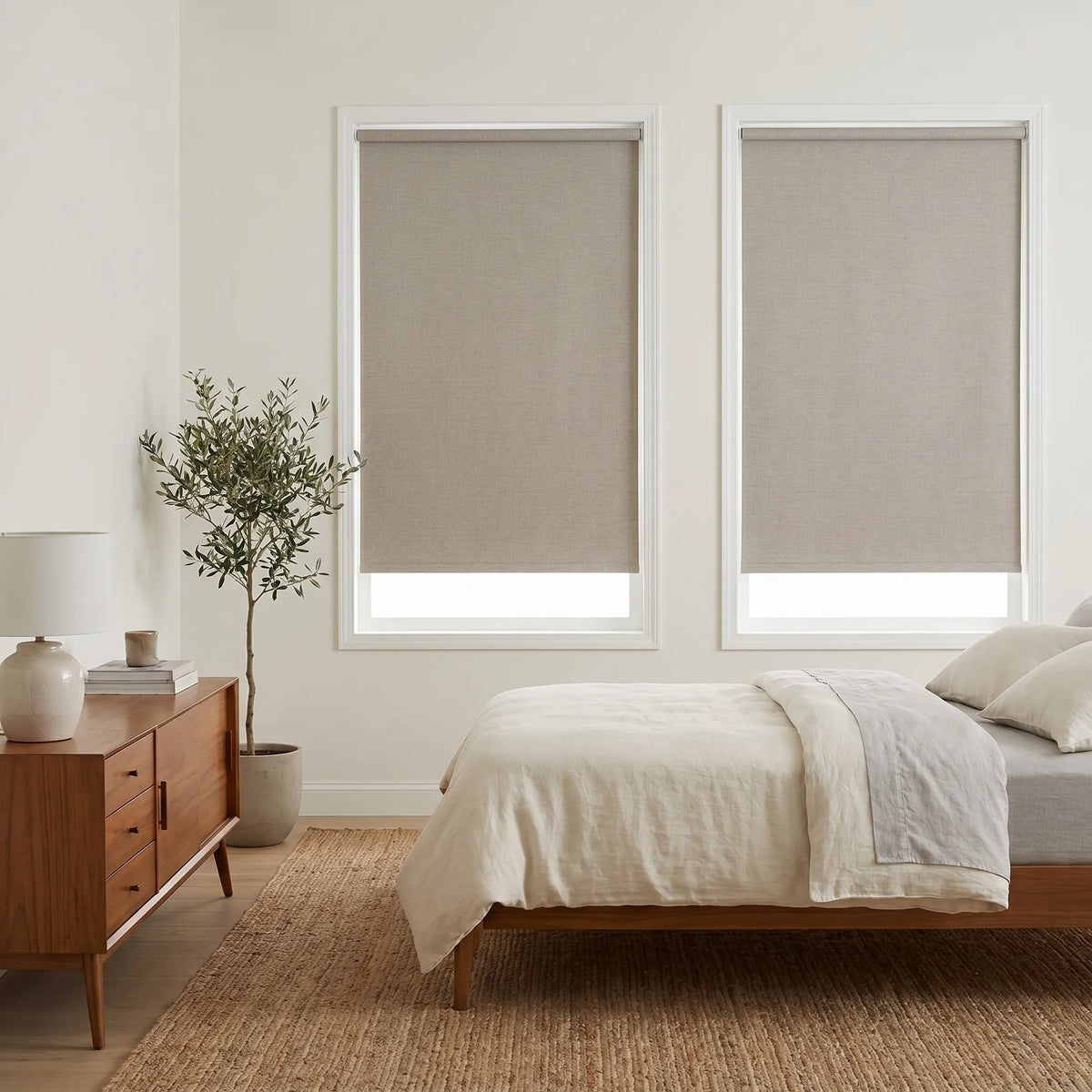 Elegant bedroom ambiance achieved with Classic Fabric Blackout Roller Shades, offering beige softness and comfort