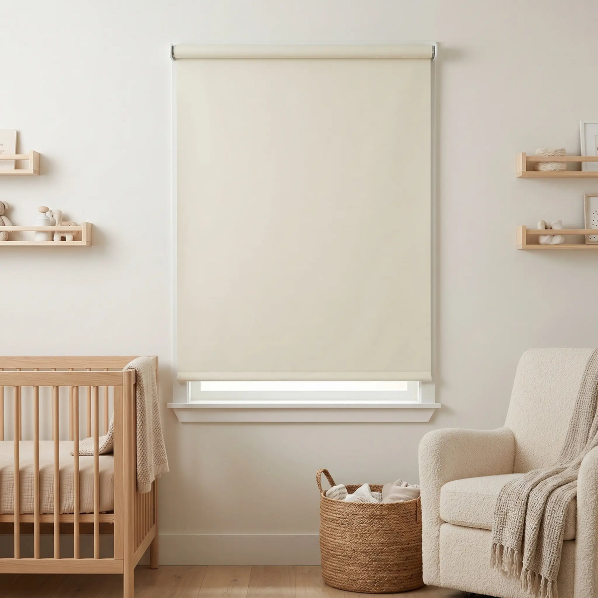 Economy Basic Vinyl Blackout Roller Shades adorn a serene nursery, softly filtering beige-hued light and creating a cozy atmosphere.
