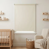 Economy Basic Vinyl Blackout Roller Shades adorn a serene nursery, softly filtering beige-hued light and creating a cozy atmosphere.
