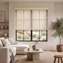 Load image into Gallery viewer, Natural light pours through this room, where a beige sofa and potted plant meet the warm tone of Hardwood Cordless Horizontal Blinds, creating a serene retreat.
