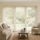 Woodtone Faux Wood PVC Vertical Blinds perfectly complement the beige tone, allowing natural light to illuminate this calm and inviting room with rich wood accents.