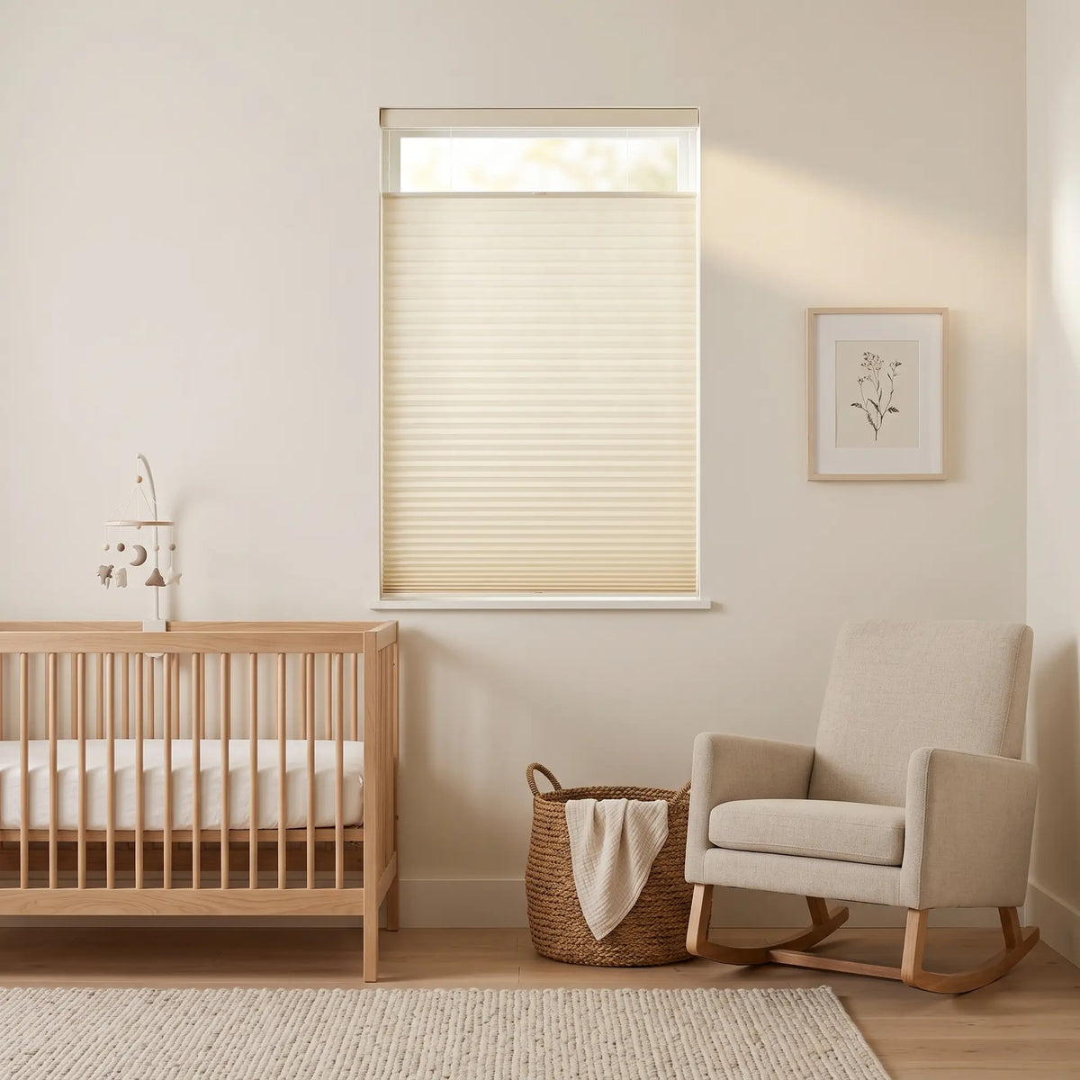 Simplistic Cordless Tdbu Pleated Shades softly filter morning light in a serene nursery, featuring a crib and rocking chair amidst a gentle beige ambiance.