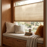 Simplistic Cordless Tdbu Pleated Shades effortlessly balance beige-toned serenity with adjustable privacy and versatile lighting in this inviting reading nook.