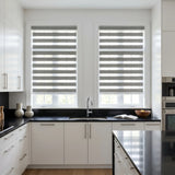 Zebra Light Filtering Roller Shades add a striking touch to this modern kitchen with black and white decor, blocking out harsh light while maintaining natural brightness