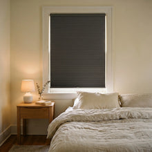 Load image into Gallery viewer, Custom window treatments: Black (Anthracite) 9 16 Inch Classic Single Cell Blackout Cordless Shades shown in a modern bedroom, keeping the space completely shaded from harsh glare.
