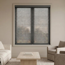 Load image into Gallery viewer, A look at Black (Anthracite) 9 16 Classic Single Cell Light Filtering Cordless Shades inside a cozy living space, allowing bright, diffused daylight to fill the interior.
