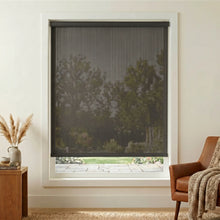 Load image into Gallery viewer, Premier 5% Solar Screen Roller Shade in black provides UV protection and stylish decor for a cozy living room with brown leather furniture.

