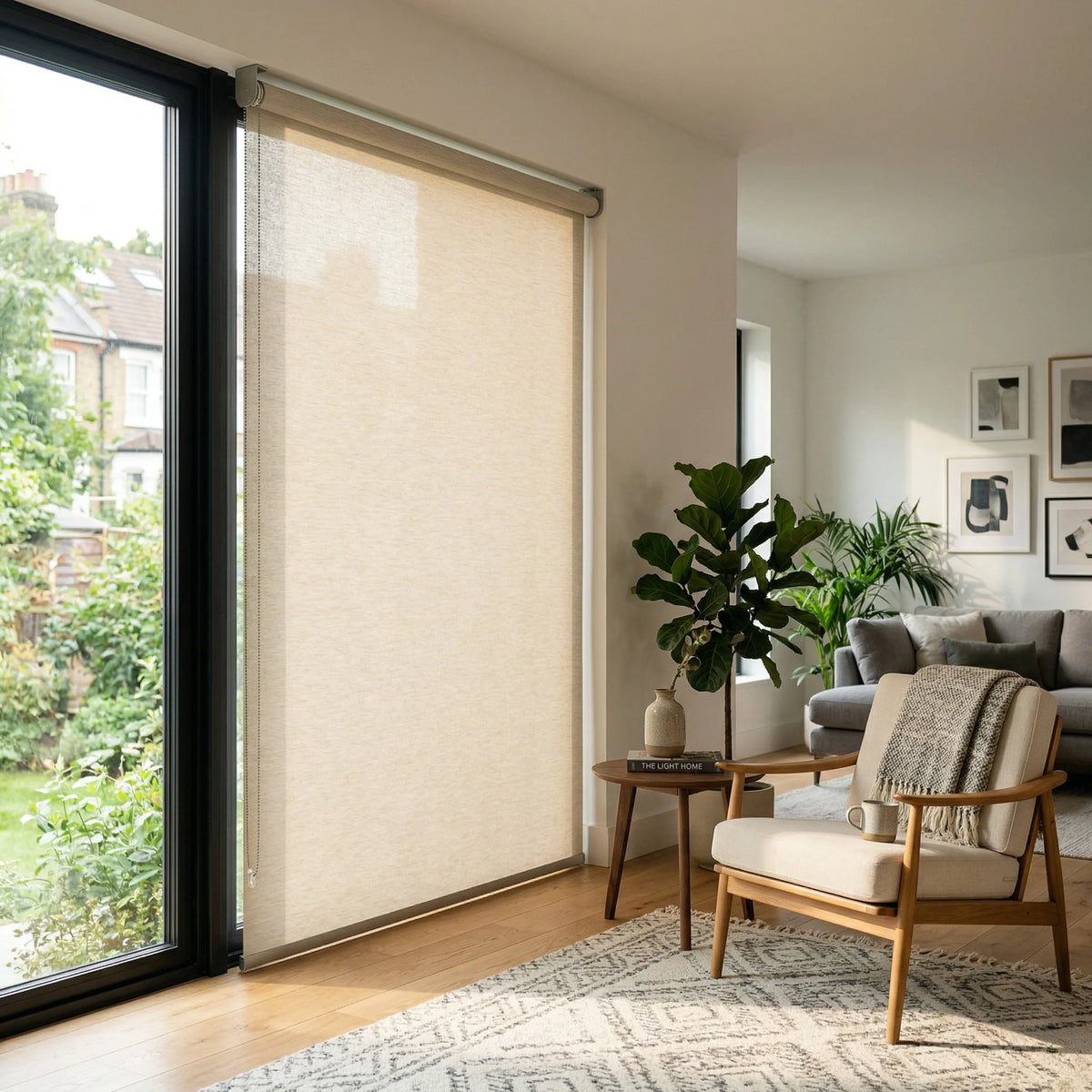 Contextual view of light brown beige Coffee light filtering roller shades in a modern living room with a mid-century armchair.