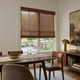 Nutmeg Natural Bamboo Shade in rich brown on a dining room window overlooking the patio