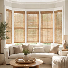 Load image into Gallery viewer, Transform your living space with Cordless Woven Wood Shades, perfectly complementing brown bamboo accents and white walls for a harmonious atmosphere.
