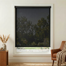 Load image into Gallery viewer, Premier 5% Solar Screen Roller Shade adds a touch of sophistication with its charcoal exterior, while providing UV protection and stylish shading for this cozy living room.


